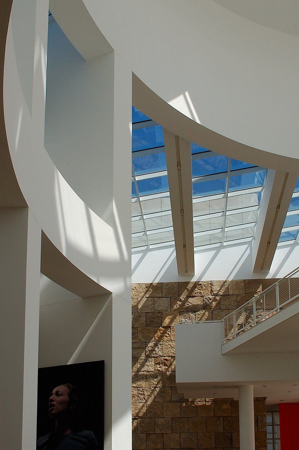 A curved white atrium opening to the sky