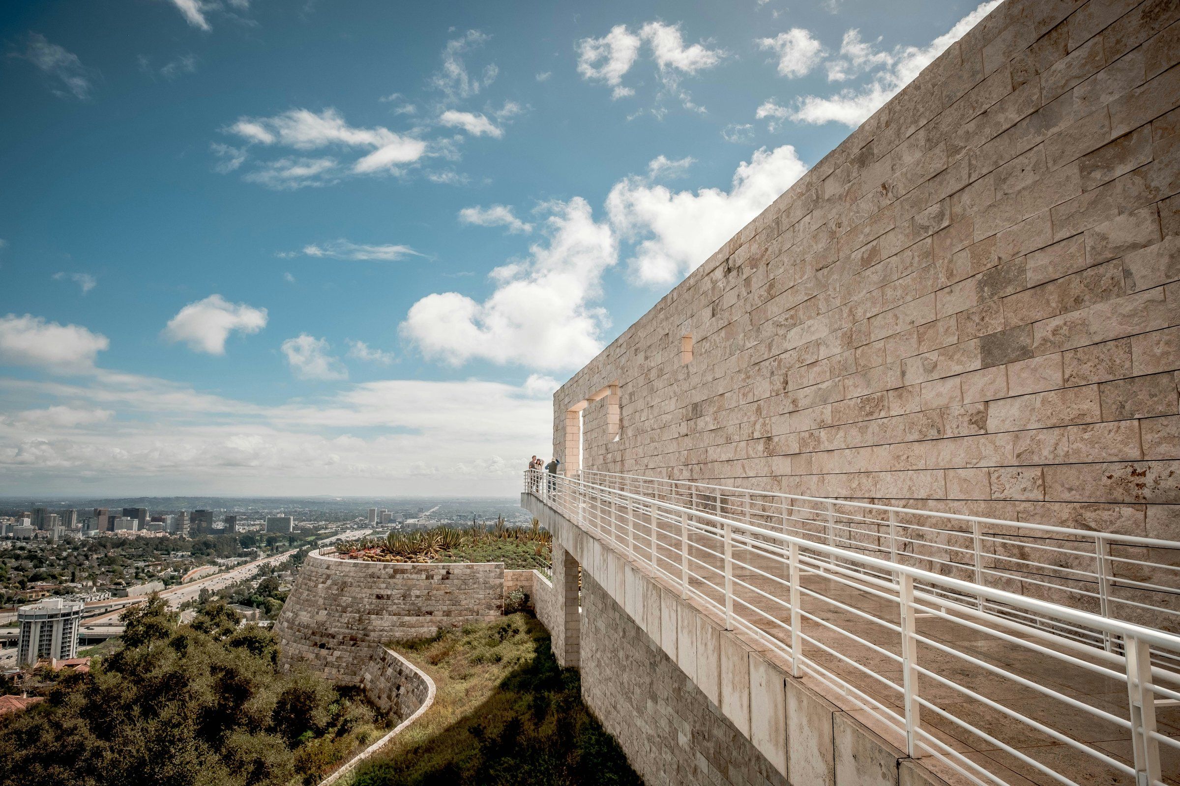 Stone terraces above Los Angeles, with the city stretching to the horizon