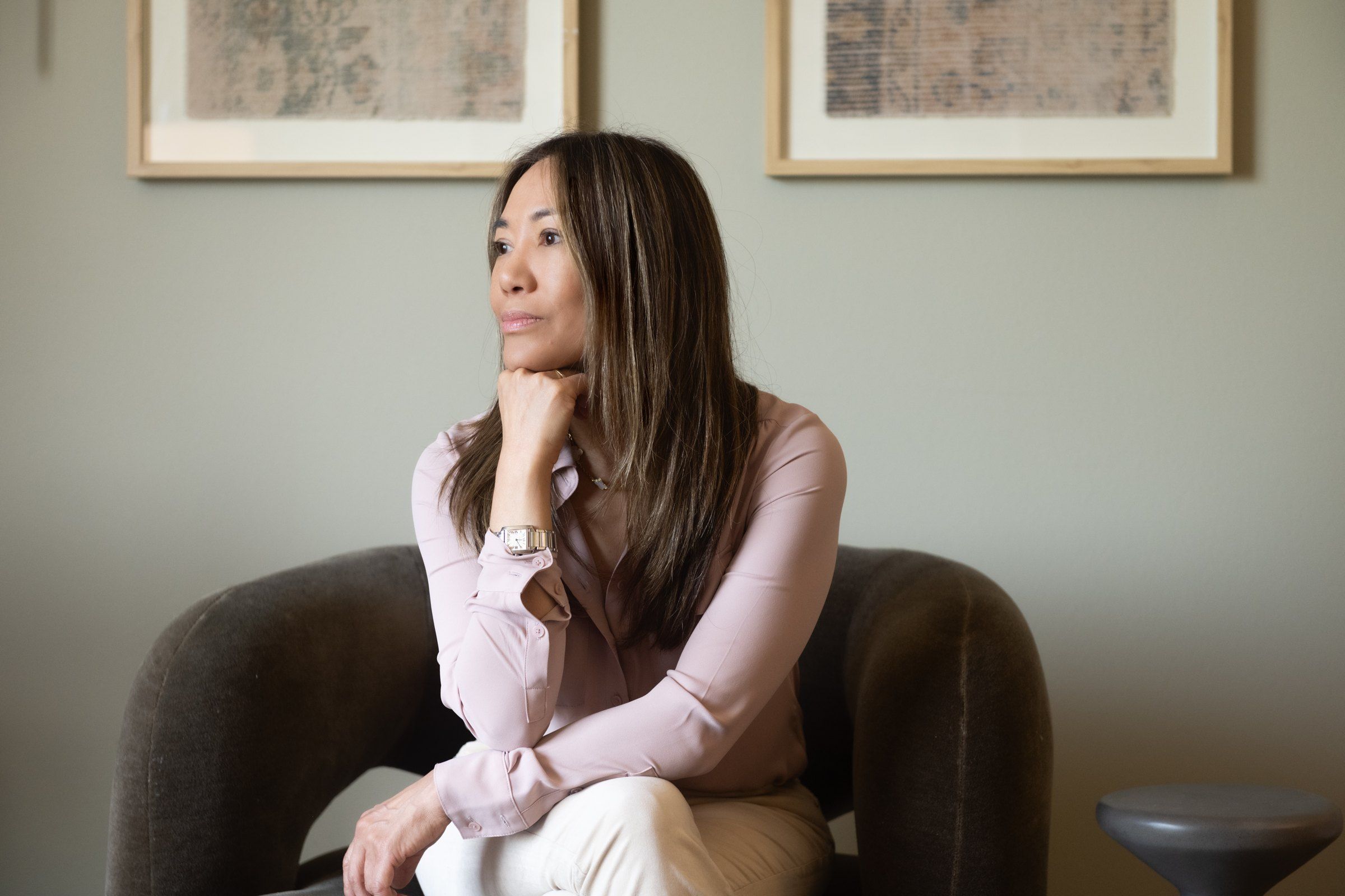 Lisa Chen seated in her office, looking out thoughtfully